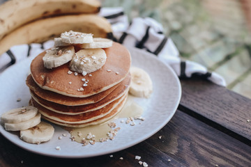 Delicious pancakes topped with banana and honey. Homemade classic american pancakes. Breakfast in the morning. 