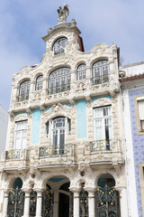 Fototapeta na wymiar Vertical photo of a facade of a historical building with a statue of a bird on the top