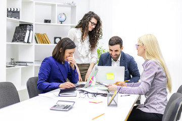 Photo of successful business team working on some project at the office.