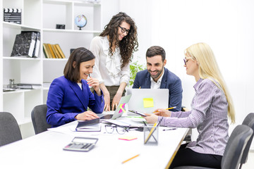 Photo of successful business team working on some project at the office.