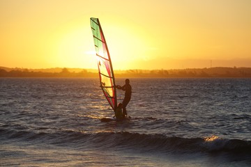 windsurfer on the water at sunset, Rio de Janeiro. Brazil