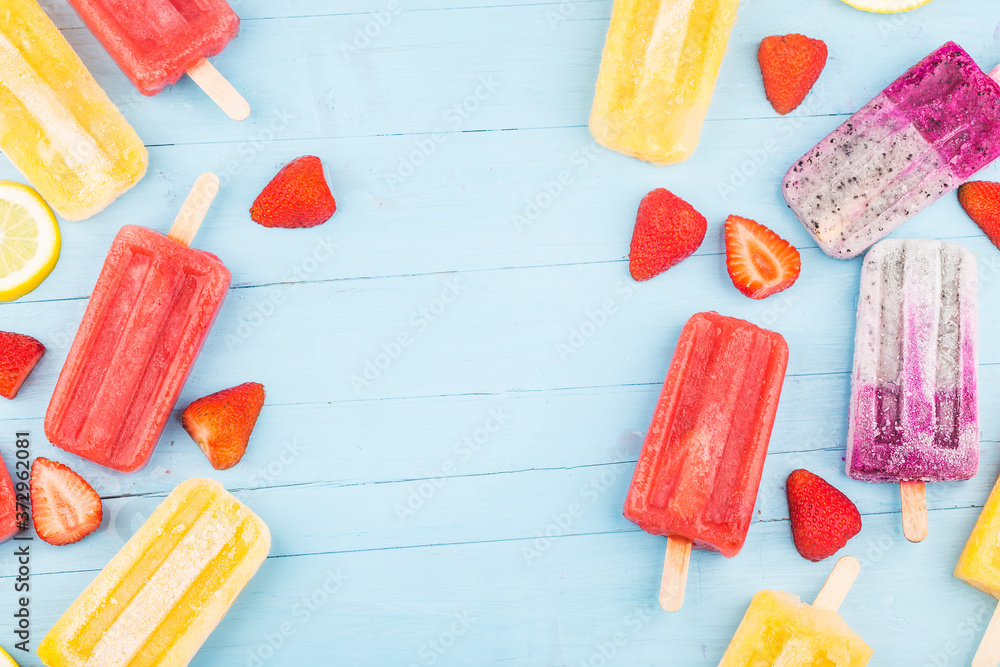 Poster Healthy Whole Fruit Popsicles with Berries Strawberry orange  Dragon fruit  on wooden vintage table