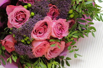 Pretty bouquet with pink roses and other small flowers, color tender roses and purple flowers 