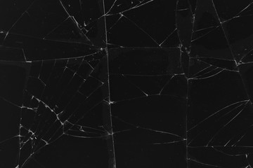 Black cracked glass texture background. Crack on the glass. Broken screen. Broken dark phone.  White cracks in glass