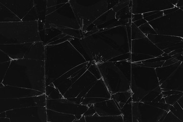 Black cracked glass texture background. Crack on the glass. Broken screen. Broken dark phone. ...