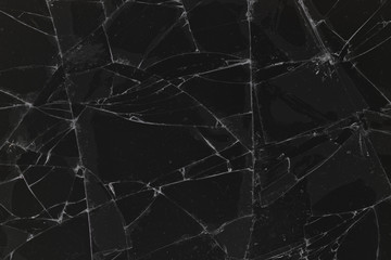 Black cracked glass texture background. Crack on the glass. Broken screen. Broken dark phone. ...