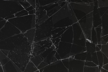 Black cracked glass texture background. Crack on the glass. Broken screen. Broken dark phone. ...