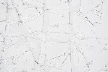White cracked glass texture background. Texture broken glass window with cracks. Broken screen.