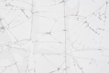 White cracked glass texture background. Texture broken glass window with cracks. Broken screen.