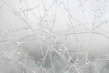 White cracked glass texture background. Texture broken glass window with cracks. Broken screen.