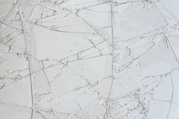 White cracked glass texture background. Texture broken glass window with cracks. Broken screen.