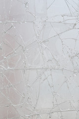 White cracked glass texture background. Texture broken glass window with cracks. Broken screen.