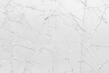 White cracked glass texture background. Texture broken glass window with cracks. Broken screen.