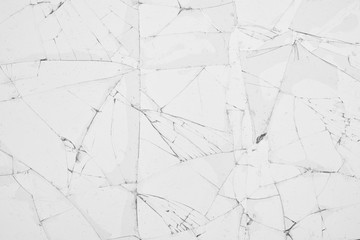 White cracked glass texture background. Texture broken glass window with cracks. Broken screen.