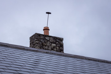 Chimney Cleaning Brush Sticking Up Out of a Chimney Pot
