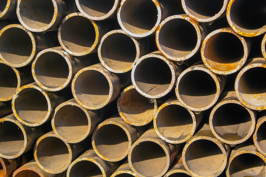 Stack of new metal pipes. Industrial material.