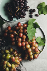 Composition with grape and towel on gray background