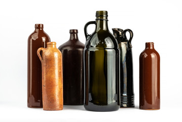 A composition of various dark bottles on a white background. Containers for alcoholic beverages. Empty used containers.