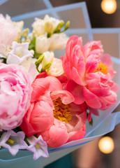 Flower shop. Beautiful bouquet of mixed flowers in man's hand. the work of the florist at a flower shop. Bright Pink color. Fresh cut flower.