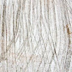 The lines on the rough gray cement floor.