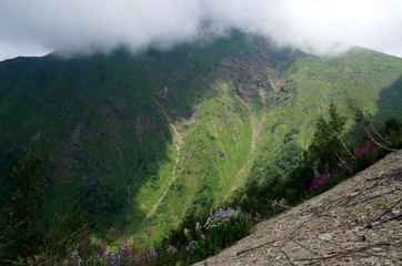Caucasus mountain biosphere reserve pass crossing with fog river sky in summer
