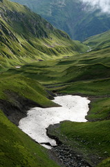 Caucasus mountain biosphere reserve pass crossing with fog river sky in summer