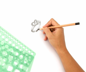 Jewelry designers are painting the ring with a pencil on a piece of paper before the model can be produced.