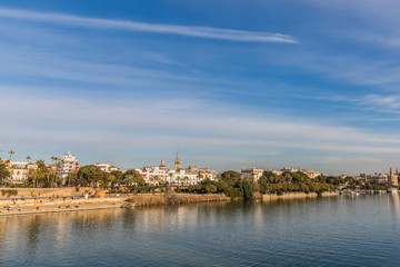 Guadalquivir river and a part of the city of Seville Spain on a wonderful sunny day and a blue sky with few white clouds