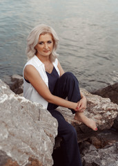 young woman sitting on the rocks