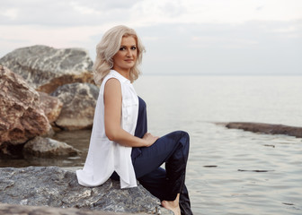 young woman sitting on the rocks