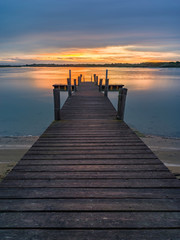Fototapeta na wymiar Lagoon landscape at dawn with wooden jetty