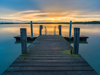 Fototapeta premium Lagoon landscape at dawn with wooden jetty