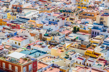 Urban landscape of the city of Almería observing houses painted with striking colors, their roofs and streets, sunny day in the municipality of Andalusia, Spain