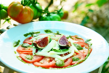 tomato carpaccio with figs served in a ecological vegetable garden