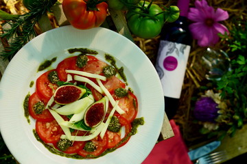 tomato carpaccio with figs served in a ecological vegetable garden