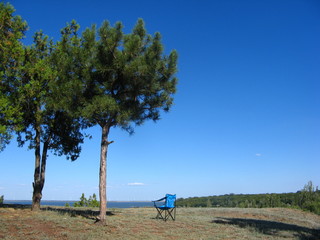 photo with a blue chair against a background of beautiful nature implying relaxation