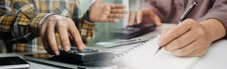 Healthcare costs and fees concept.Hand of smart doctor used a calculator for medical costs in modern hospital