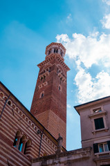 Fototapeta premium Red brick medieval Lamberti tower in Verona, Italy.