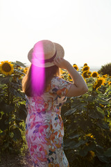 A girl with hat in sunflowers