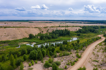 Fototapeta na wymiar Sand pit near the village of Khromtsovo on a sunny summer day.