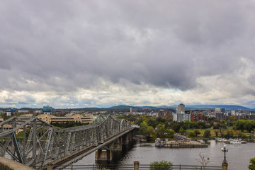Fototapeta na wymiar Parliament Hill, Ottawa, old bridge of Rideau canal in Autumn. Cloudy sky