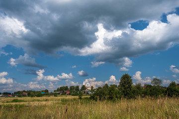 Obraz premium View of the village of Dunilovo and an ancient temple with white domes, Ivanovo region, Russia.