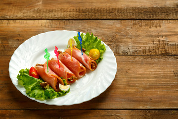 Rolls with cheese and garlic on a plate with quail eggs salad on a wooden table. save a place.