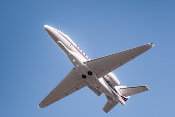 Private airplane ascending after take off from an airport in California
