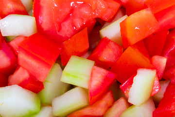 delicious salad of green cucumbers with red tomatoes, vegan snack to be healthy