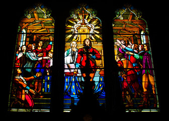 stained glass with cross in catholic church