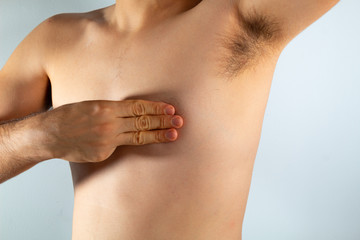 close up of a man's chest looking for signs of male breast cancer