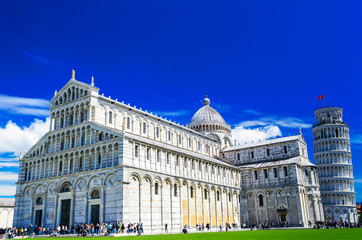 Fototapeta na wymiar Piazza del Duomo grassy expanse that's home to the landmark grand marble-striped Pisa Cathedral (Cattedrale di Pisa) and Leaning Tower of Pisa (Torre di Pisa)