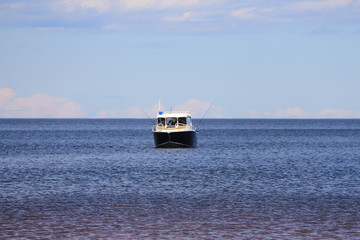 small boat in the distance on the horizon. Big lake