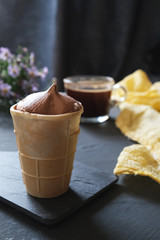 Delicious chocolate ice cream in a waffle cone.
